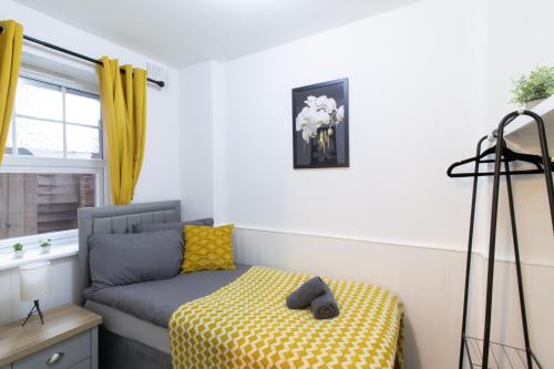 a room with a bed and a couch and a window at Open Mind Property - Cosy Apartment with 3 Beds in Portsmouth