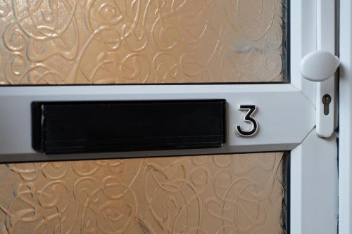 a door with the number three on it at Open Mind Property - Cosy Apartment with 3 Beds in Portsmouth