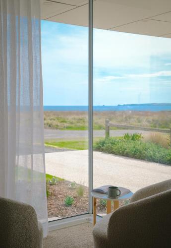 a living room with a view of the ocean at Oceanview Escape - Luxe Coastal Retreat with Hot Tub in Surf Beach