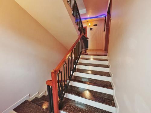 a staircase in a house with lights on the stairs at IvyArk Residency in Pinangode