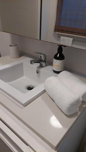 a bathroom sink with a white towel on it at Serenity home in the heart of city in Sydney