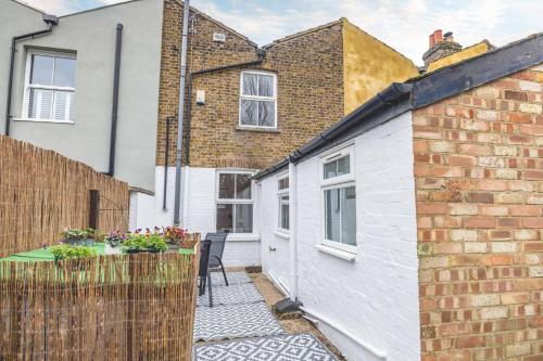 a view of the courtyard of a house with a patio at 2BR Character Home Minutes from Windsor, Private Garden - By Tempstay in Windsor
