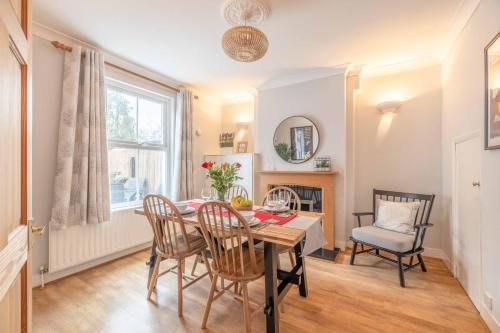 a dining room with a table and chairs at 2BR Character Home Minutes from Windsor, Private Garden - By Tempstay in Windsor