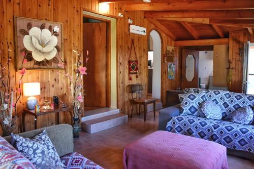 a living room with a couch and a table at Pear Tree Cottage in Lixouri
