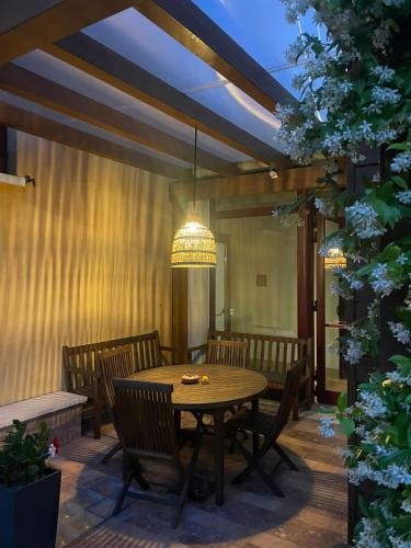 a patio with a table and chairs and a chandelier at UNAHOTELS Eco Hotel Villa Costanza Venezia in Mestre
