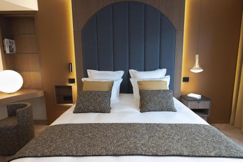 a bedroom with a large bed with two pillows at 1.75 Paris La Source in Paris