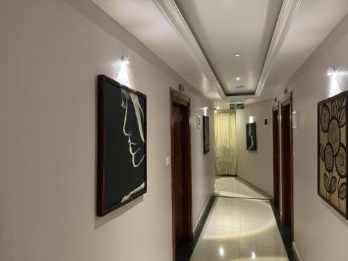a hallway with paintings on the walls of a building at IvyArk Residency in Pinangode