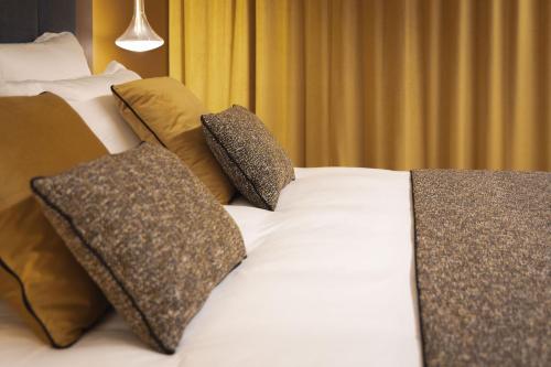 a bed with two pillows on top of it at 1.75 Paris La Source in Paris