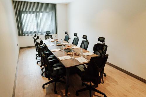 a large conference room with a long table and chairs at The Emporia Hotel in Pamukkale
