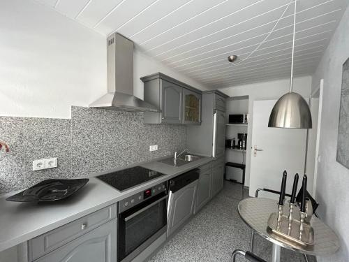 a kitchen with a sink and a stove top oven at Haus Arthur Klingels in Bad Bertrich