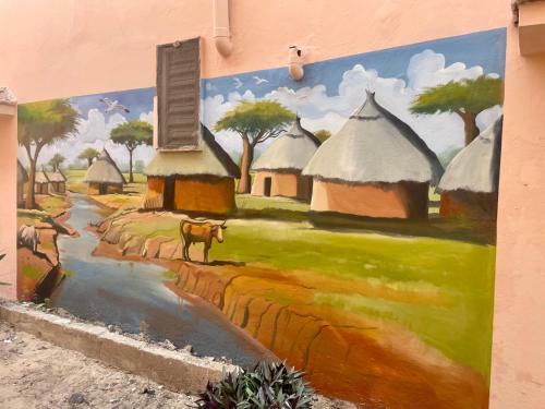 a mural of an african village with a river at Fadidi House in Dakar