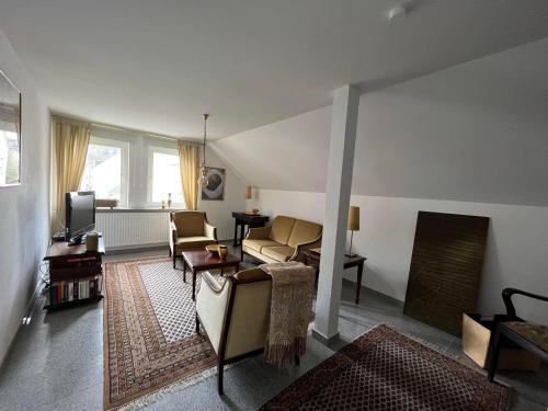 a living room with a couch and a tv at Haus Arthur Klingels in Bad Bertrich