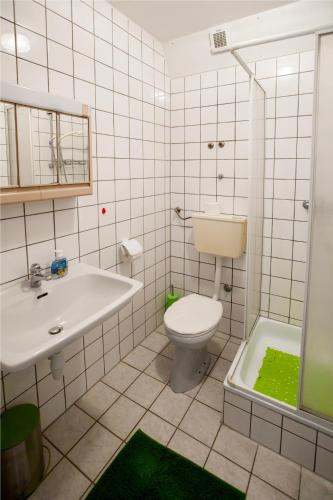 a bathroom with a toilet and a sink at Friendly People's Guest House in Zadar