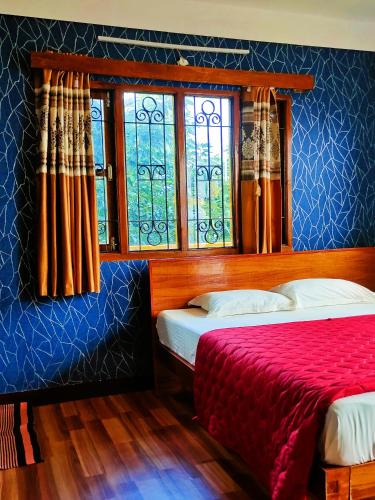 a bedroom with two beds and a window at Misba Homestay Kodai in Kodaikānāl