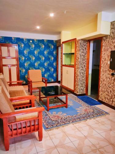 a living room with a couch and a table at Misba Homestay Kodai in Kodaikānāl