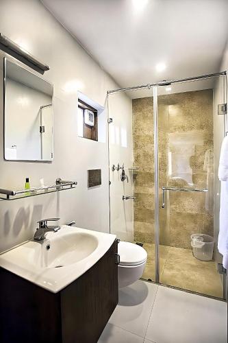 a bathroom with a sink and a toilet and a shower at Seaflare Beach Resort & Spa in Pallipuram