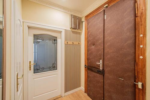 a hallway with a door and a window and a door at Radost Residence The Heart of Unique Living in Prague