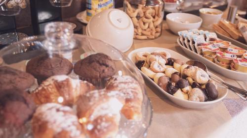 a table with a bunch of pastries and other desserts at La Gelsomina - Etna in Presa