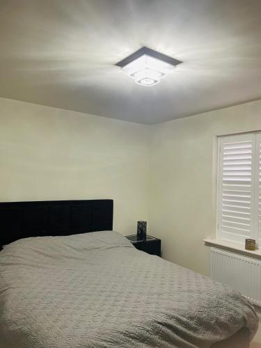 a bedroom with a bed and a ceiling fan at House-Sleeps 8-Parking-Garden-Country Surroundings in Kettering