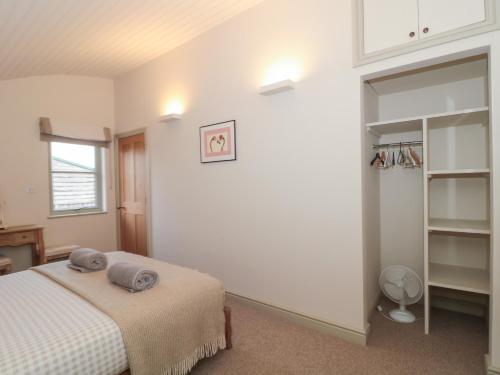 a bedroom with a bed with two pillows on it at Dutch 1 in Lechlade