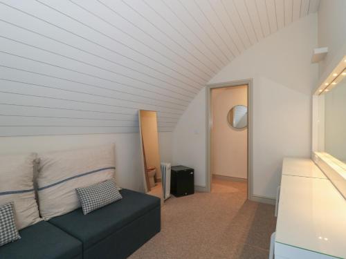 a living room with a couch and a hallway at Dutch 1 in Lechlade