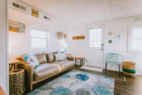 a living room with a couch and a table at NH337A Coastal Dunes 1 in Nags Head