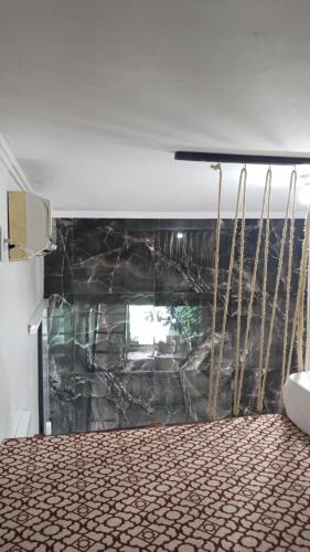 a room with a fireplace with a stone wall at Kitnet MiniHouse do Alto in Lençóis