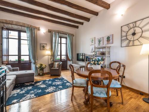 a living room with a table and chairs at Estay - Charm in Villanova in Cagliari