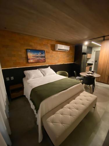 a bedroom with a large bed and a table at New time 1216 in Maceió