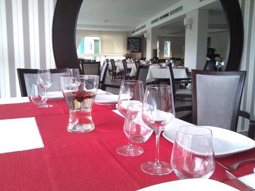 a table with wine glasses on a red table cloth at Al Mandari Hôtel Tétouan in Tetouan