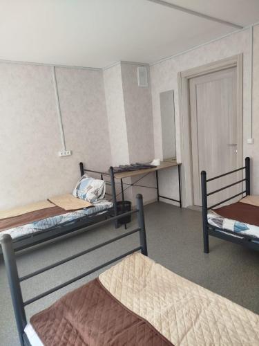 a room with three bunk beds and a door at Хостел єЖитло Щекавиця in Kyiv