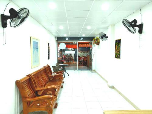 a waiting room with brown chairs and a table at Marine Guest House Encore in Pattaya South