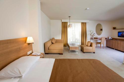a hotel room with a bed and a living room at Dream Family Club in Side