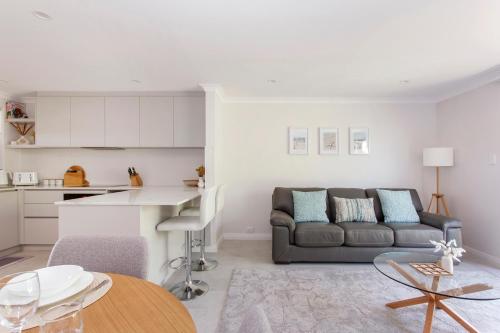 a living room with a couch and a table at Maylands Riverside City Retreat in Perth