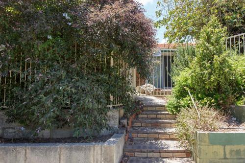 a set of stairs in a garden with trees at Maylands Riverside City Retreat in Perth