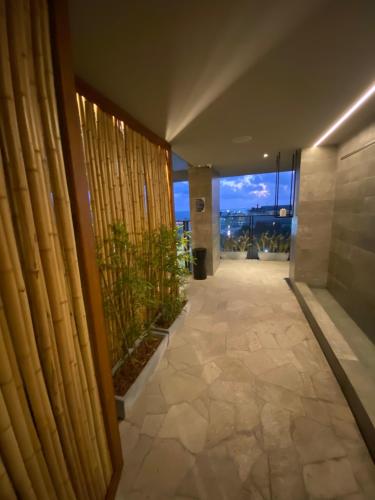 a hallway of a building with a view of the ocean at New time 1216 in Maceió