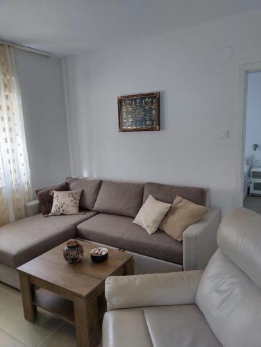 a living room with a couch and a table at Apartments Miličević in Gradac