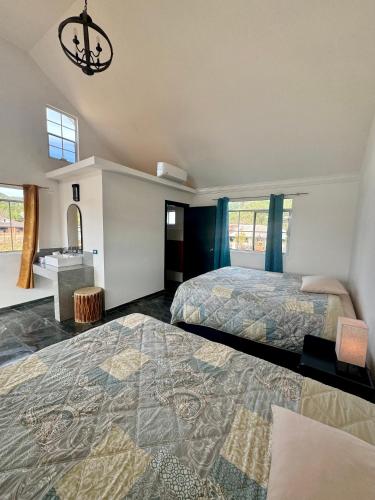 a large bedroom with two beds and a bathroom at Valle de Cerocahui Hotel in Cerocahui