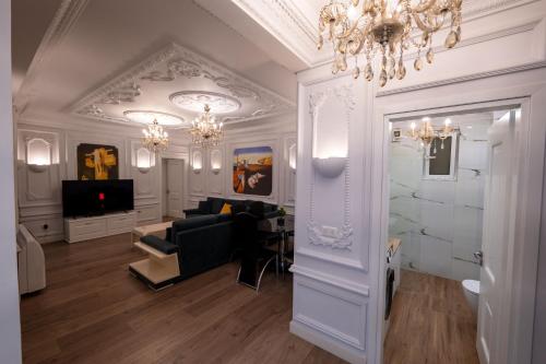 a living room with a chandelier and a couch at Luxury Apartment in Sarandë