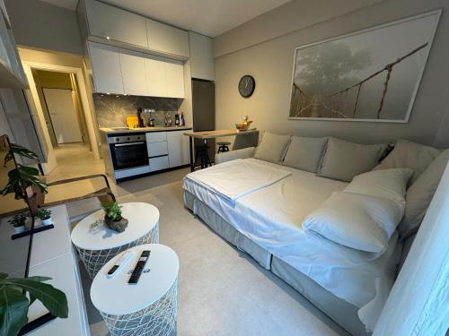 a bedroom with a large bed and a kitchen at Eleni Siviri in Siviri