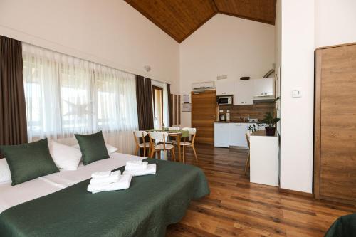 a living room with a white couch and a kitchen at B&B Apartments Burić Plitvice Lakes in Plitvička Jezera