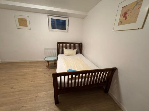 a small bedroom with a bed and a chair at Business Apartment in Kaiserslautern