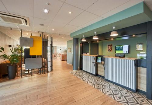 a lobby of a fast food restaurant with a counter at B&B HOTEL Ouistreham in Ouistreham