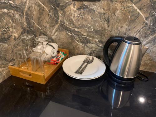 a coffee pot and a plate on a table at Wave Crest Villa in Dickwella