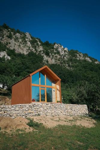 a house with a large window on a mountain at Ostrog Wood House in Železnička Stanica Dabovići
