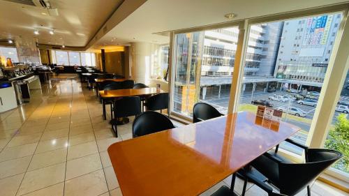 a restaurant with tables and chairs and a large window at Hotel Clio Court Hakata in Fukuoka