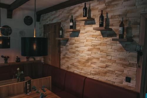 a brick wall with wine bottles on it at Hillmers Hoff PensionRestaurant in Undeloh