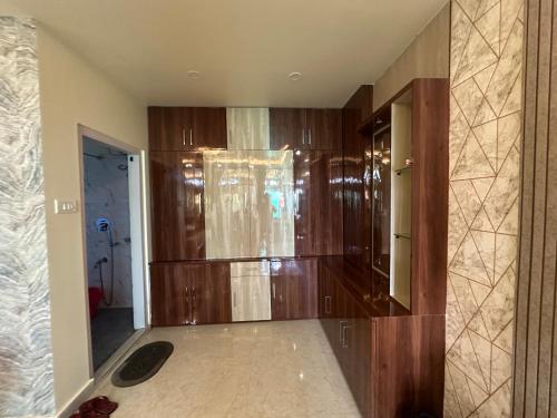 a room with a large wooden closet in a house at Niribili Homestay in Majuli