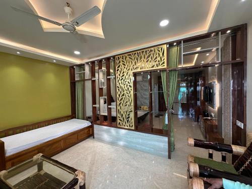 a room with a bed and a glass window at Niribili Homestay in Majuli