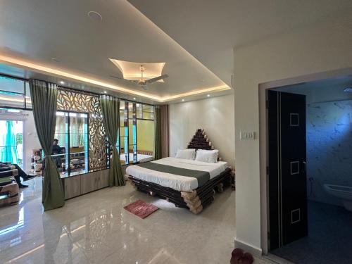 a bedroom with a bed and a tv in a room at Niribili Homestay in Majuli